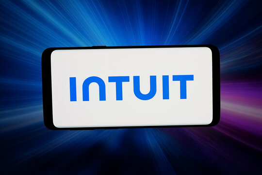 Stuttgart, Germany - 03-26-2026: In this photo illustration, the logo of US business software company Intuit Inc. is displayed on a smartphone in front of abstract background on computer screen.