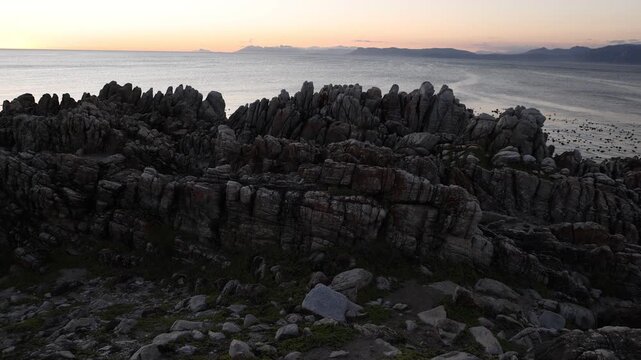 Rocky coastline, DeKelders,  South  Africa, overlooking Walker Bay Nature Reserve and Klein Mountains