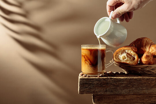Coffee latte with croissants on an old wooden table.
