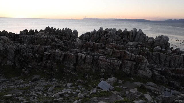 Rocky coastline, DeKelders,  South  Africa, overlooking Walker Bay Nature Reserve and Klein Mountains