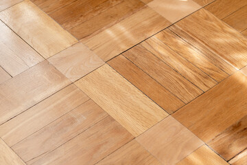 Close-up of light oak parquet flooring showing square hardwood pattern, natural grain and warm tones. Ideal for interior design, renovation, background textures, home decor and architectural detail © evannovostro