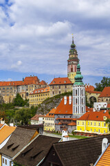 Obraz premium Cesky Krumlov view with castle tower across Vltava river in Czechia. Medieval town architecture under cloudy sky