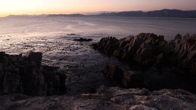 Rocky coastline, DeKelders,  South  Africa, overlooking Walker Bay Nature Reserve and Klein Mountains