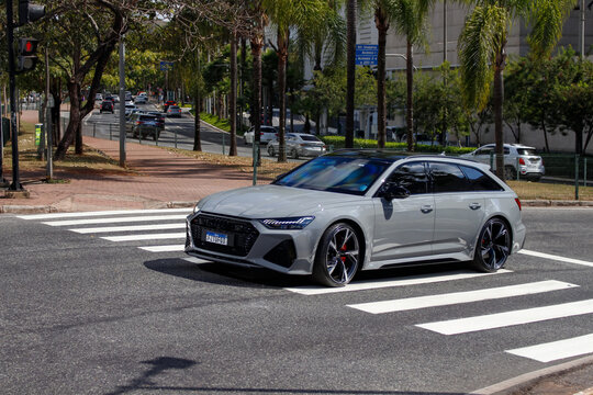 Grey Audi RS6 Avant front three quarters in movement, Luxury station wagon car crossing city street