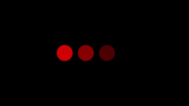 Animated 4 dots blinking loader. Ellipsis. Simple black and white loading icon. 4K video footage with alpha channel transparency.