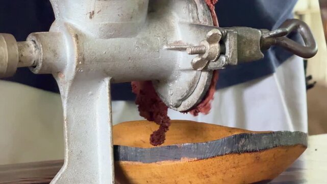 Closeup of Grinding Cacao Beans With a Hand Grinder