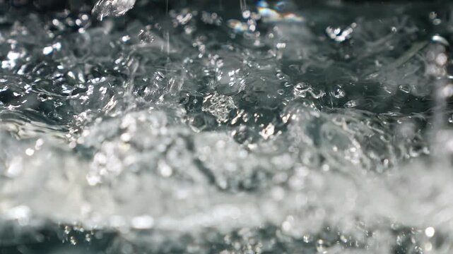 Ice cubes falling into water with oxygen bubbles, frost patterns, and soft light reflections. Concepts for beauty advertising, menu designs for bars and restaurants, cryotherapy.