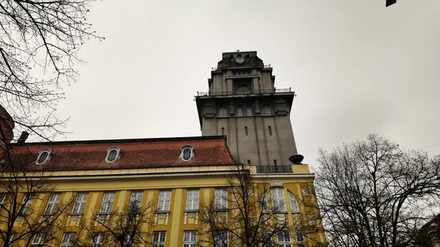 Historic city hall with clock tower and surrounding architecture in Senta Serbia under cloudy sky, highlighting urban heritage, administration and European cityscape