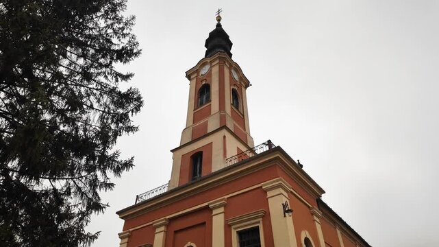Red small Church building in Senta Serbia, creating perspective and symbolizing spiritual journey and calm atmosphere