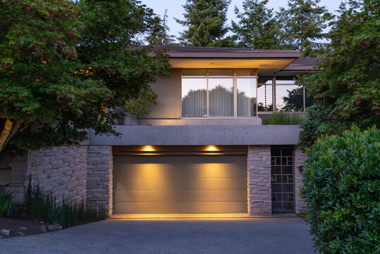 Two story stucco luxury house with big tree and nice landscape at night at Summer in Vancouver, Canada, North America. July 2025.
