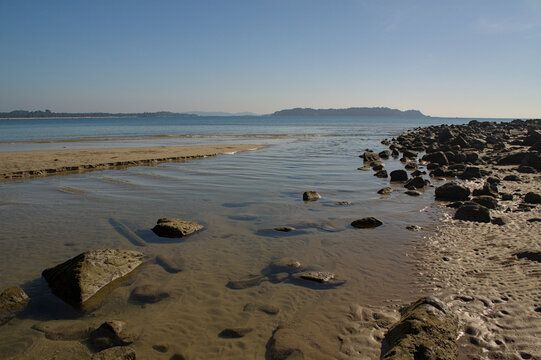 Rocky beach with calm sea and coastline in Ngapali Myanmar, natural tropical landscape in Southeast Asia.