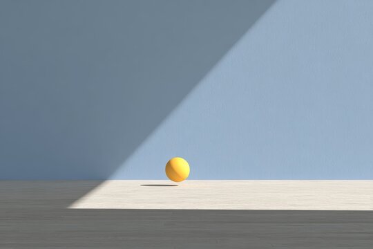 A yellow egg sitting atop a wooden floor with a wall in the background.