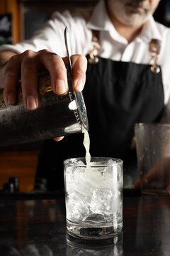 Bartender Pouring Cocktail on Rocks