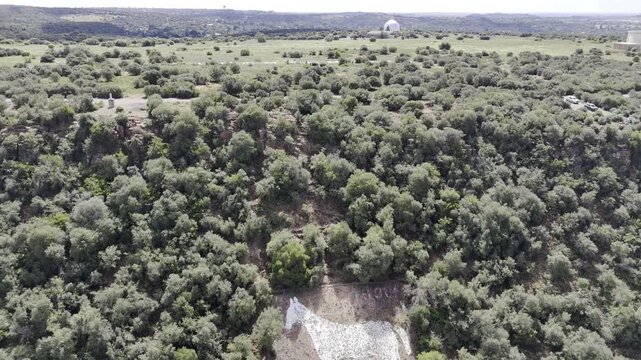 Drone lowers in medium shot of White Horse monument on side of Naval Hill on partially cloudy afternoon in Bloemfontein, South Africa