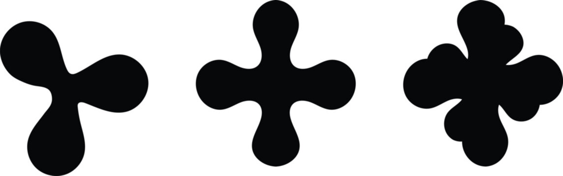 Abstract black inkblot shapes a rorschach like composition of three unique organic forms on white background