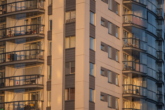 Modern apartment building with curved balconies in sunlight
