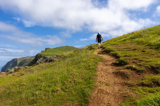 Woman takes a hike over the hills along the coastline on Portuguese Madeira
