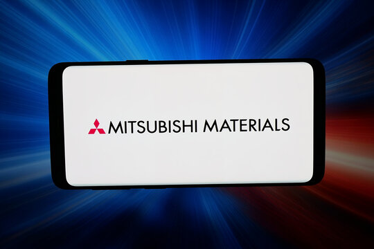 Stuttgart, Germany - 03-26-2026: In this photo illustration, the logo of company Mitsubishi Materials Corp. (MMC) is displayed on a smartphone in front of abstract background on computer screen.
