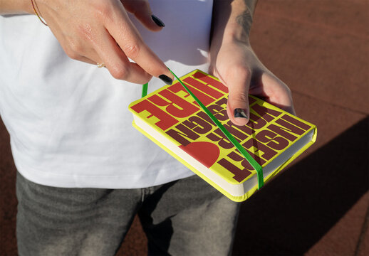 Mockup of a Book Cover Design in Hand