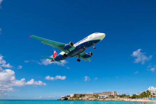 JetBlue Airways Airbus 320 flying over Maho Beach before landing on Princess Juliana International Airport SXM on Sint Maarten, Dutch Caribbean. 