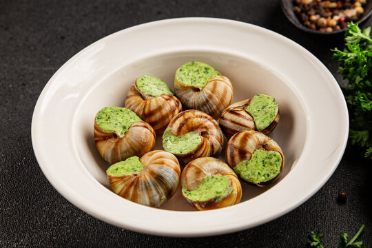Escargot food with green butter French cuisine food preparation tasty snack fresh delicious gourmet food background on the table rustic food top view copy space