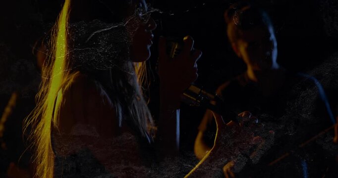 Singer stepping to retro mic, starting music, singing, guitar playing, rim-lit scratches overlaying