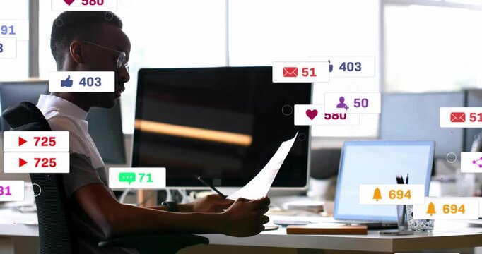 Marketing man reviewing document at desk while alerts appearing, covering monitors, receding
