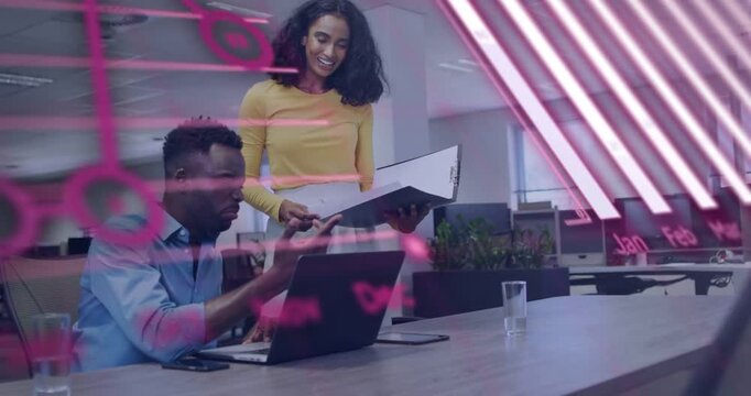 Woman approaching binder pointing, man typing laptop, pink charts red code sweeping business review