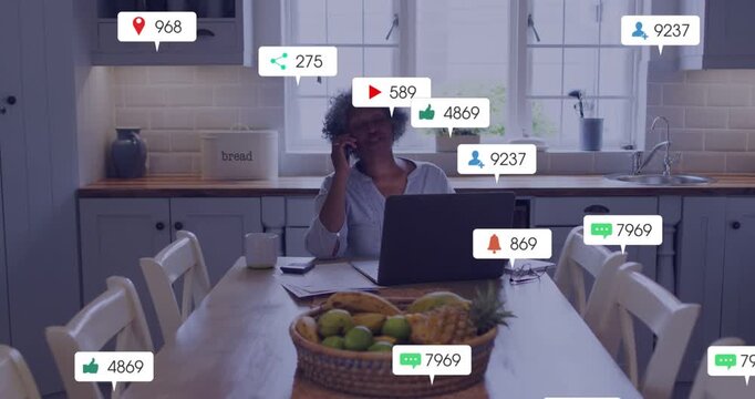 Senior woman starting phone call at table, animated marketing engagement alerts growing over laptop