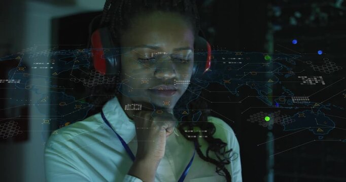 Female tech touching raised hand in data center, showing projected map overlay while checking racks