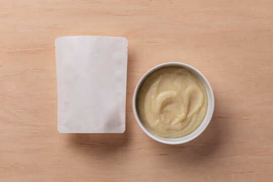 Still Life Pack Shot of Empty Baby Food Packaging with Product Sample
