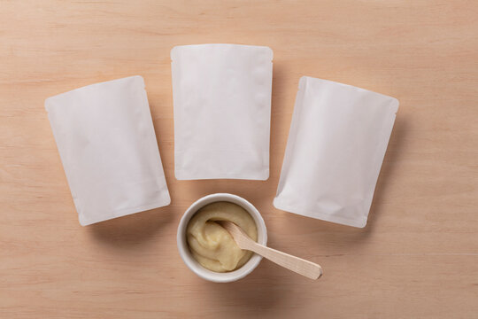 Still Life Pack Shot of Empty Baby Food Packaging with Product Sample