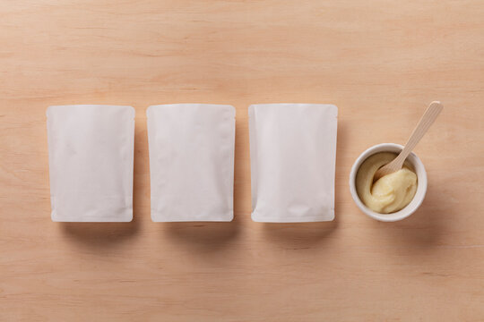 Still Life Pack Shot of Empty Baby Food Packaging with Product Sample