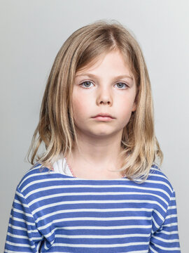 Studio Portrait of a Young Girl with a Serious Expression.