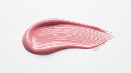 Fototapeta premium A soft pink creamy cosmetic smear with a glossy texture smoothly spread on a clean white background in a minimal beauty style.