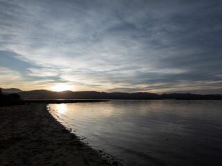 Sunset over tranquil bay with water reflection © larrui