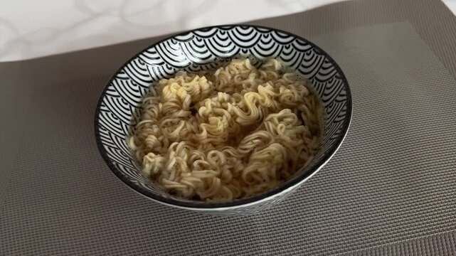 Bowl of cooked instant ramen noodles in patterned ceramic