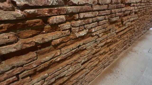 Old rustic crumbling brick wall textured close-up indoor masonry surface