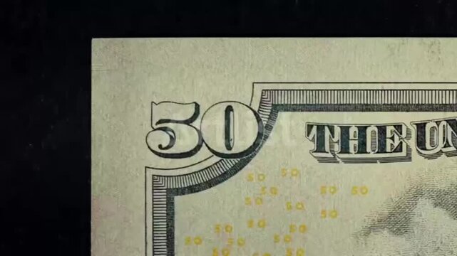 A close-up video of multiple dollar bills - Match cut effect video on dollar bills.