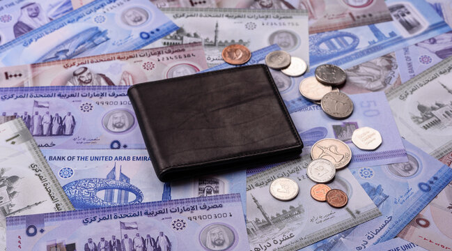 United Arab Emirates cash, dirhams and coins for exchange and financial transactions. UAE currency