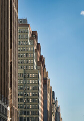 Manhattan architectural facades under a clear blue sky in New York City