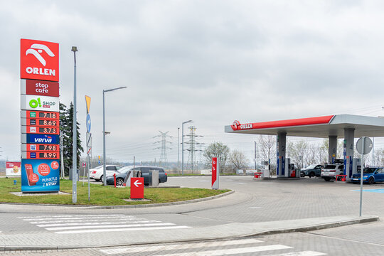 ZABRZE, POLAND - MARCH 29, 2026: Cars refueling at an Orlen petrol station. Price board showing current fuel costs. Orlen is a Polish multinational energy corporation.