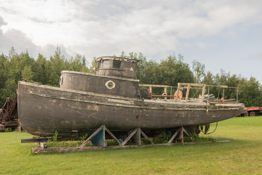 Old wooden boat put up on land 