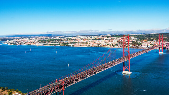 The 25 de Abril Bridge is a iconic red suspension bridge in Lisbon, Portugal, inaugurated on August 6, 1966, to connect the city with Almada over the Tagus River.