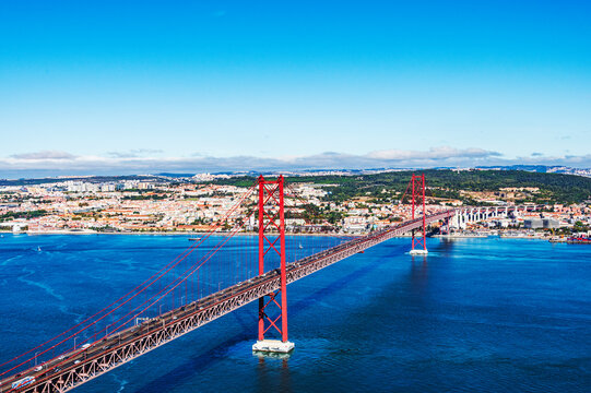 The 25 de Abril Bridge is a iconic red suspension bridge in Lisbon, Portugal, inaugurated on August 6, 1966, to connect the city with Almada over the Tagus River.