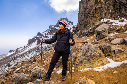 Adventurer trekking through snowy mountain terrain