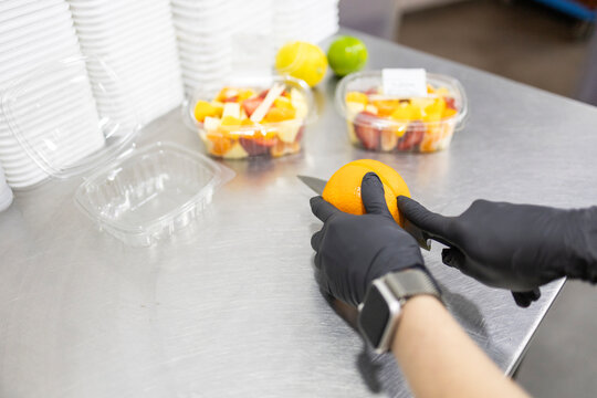 Shop assistant preparing fresh fruit at grocery store