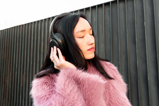 Young woman enjoying music with headphones