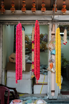 Colorful flower garlands hanging in an Indian shop