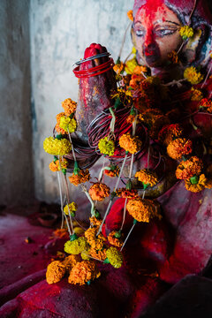 Statue adorned with vibrant floral garlands